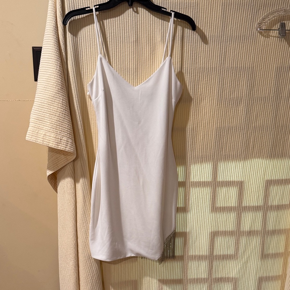 City Studio White sun cami slip mini dress featuring diamond fringe on left hem.